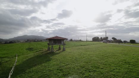 Slow-dolly-backwards-shot-from-a-horreo,-typical-granary-from-Asturias-the-north-of-the-Iberian-Peninsula,-traditional-farm-building