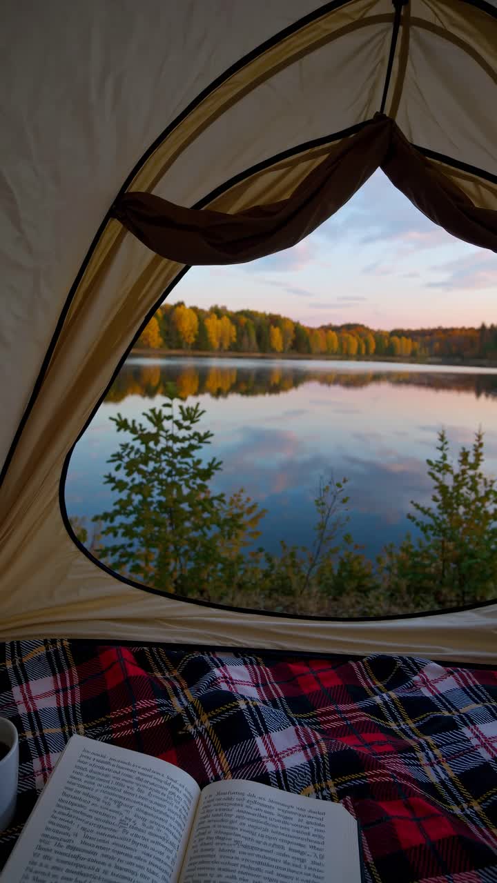 A serene lakeside view from inside a tent, captured at eye level