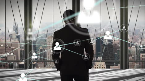 network of connections animation over businessman looking at cityscape through window