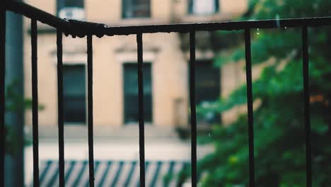 slow-motion-raindrops-falling-off-an-old-iron-railing-off-a-fire-escape-in-New-York-City