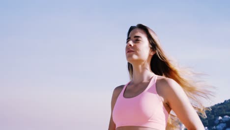 fit woman jogging on the beach