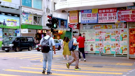 people walking across a vibrant city intersection