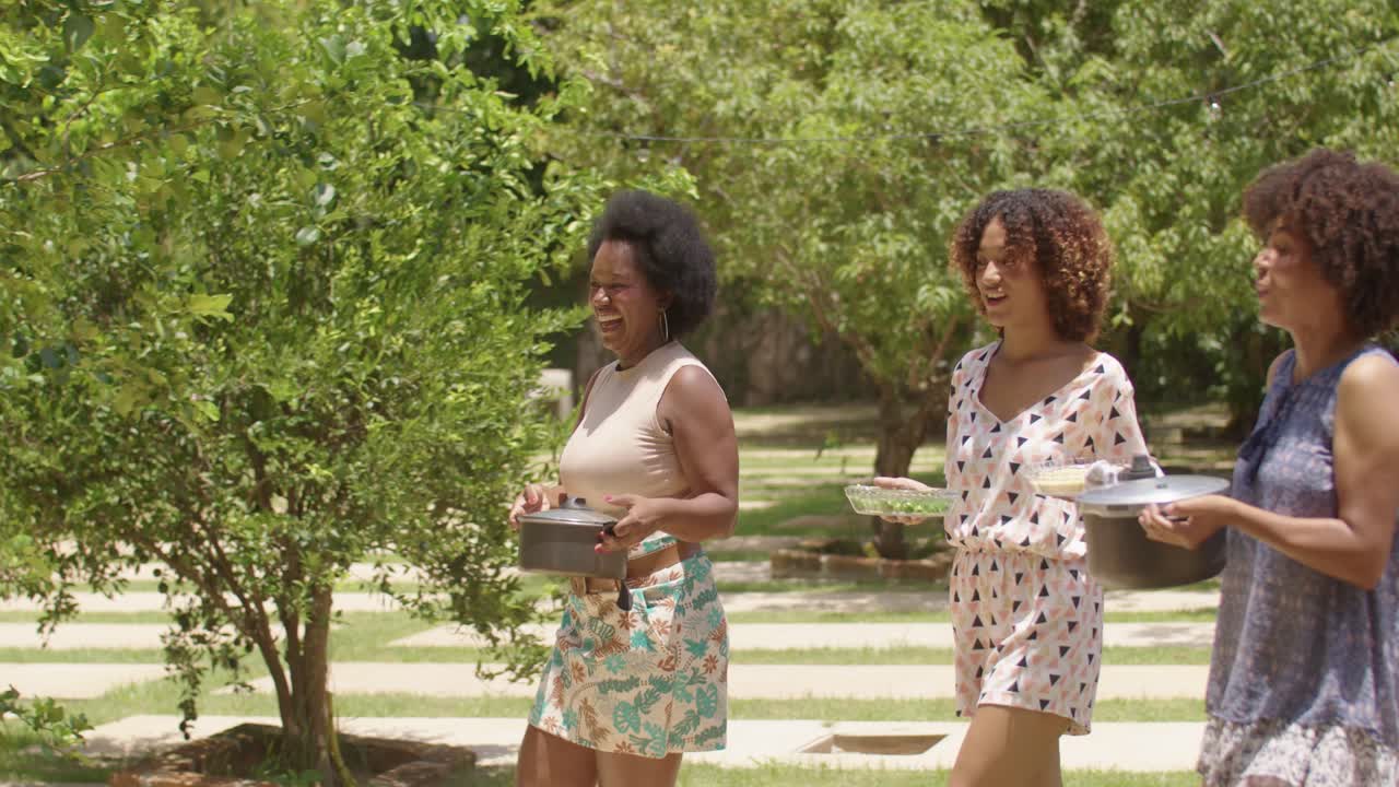 Family and Friends Enjoying an Outdoor Meal Together