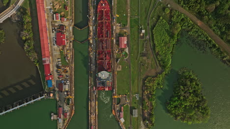 panama city aerial v41 cinematic vertical top down view flyover miraflores lake towards the canal locks with tanker ships transiting at the facility - shot with mavic 3 cine - march 2022