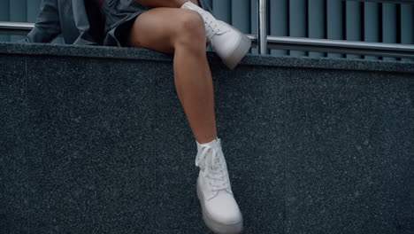 Female-model-legs-sit-posing-in-urban-building-city-downtown.