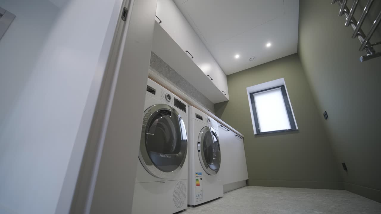 Washing machine with clothing inside a drum during cleaning and washing.Laundry room interior.
