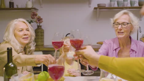 family toasting during a dinner at home