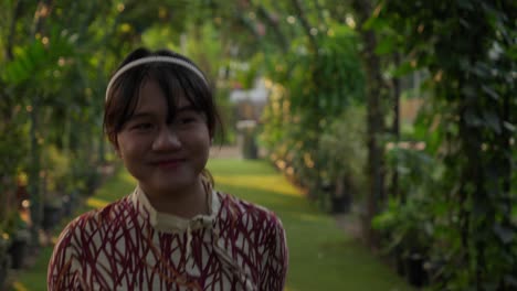 portrait of a smiling young woman in a garden