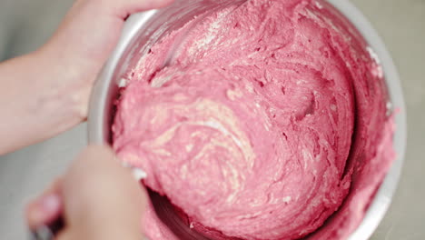 mixing pink cake batter