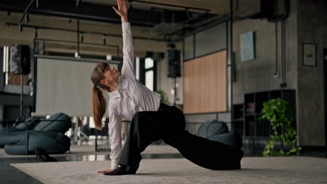 businesswoman stretching in modern home office