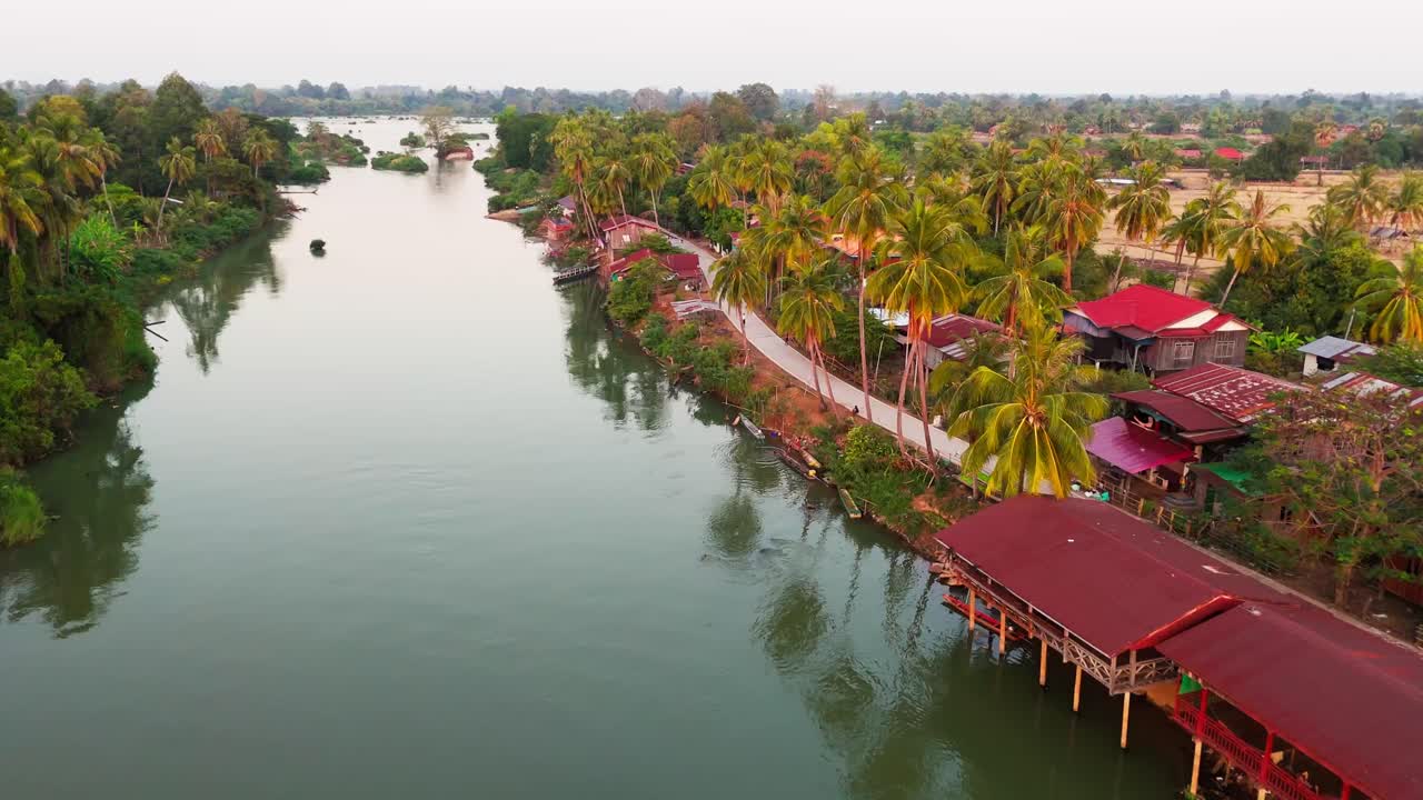 Aerial establishing of Four Thousand Islands, Si Phan Don village in Laos traditional houses by the Mekong River