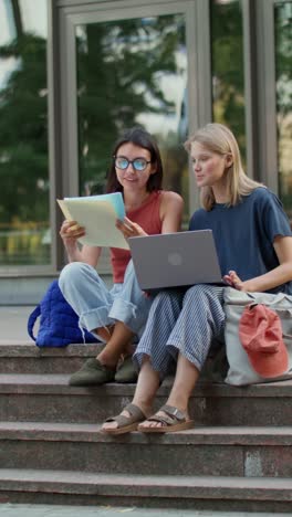 two students studying together outdoors