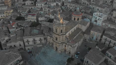 close up aerial shot of cathedral of saint george in historic town of modica, italy