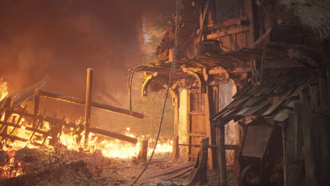 burning wooden house in old village