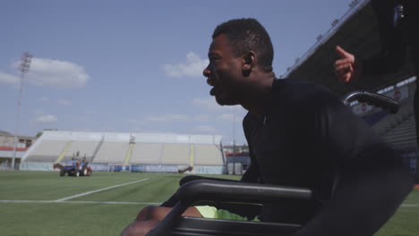 man in wheelchair at a soccer stadium