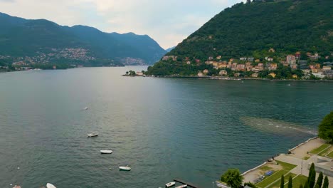 4k aerial drone video of boats on beautiful lake como, italy in the summer