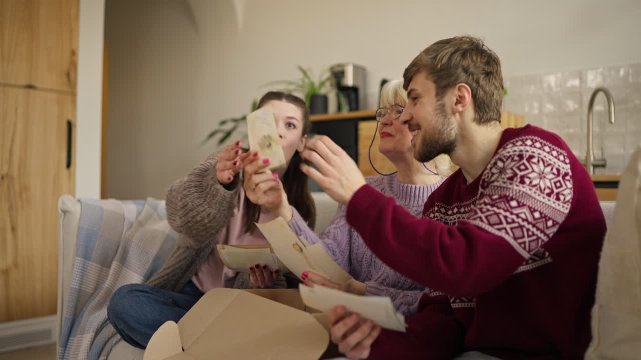 Family Reminiscing Over Old Photos
