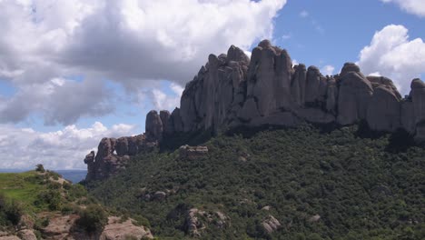 lush green montserrat mountain rock ridge aerial dolly right across impressive spanish mountain attraction