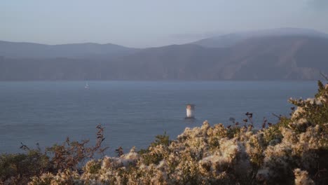 Mile-Rock-Lighthouse-and-Flowing-Flowers-on-a-Clear-Summer-Sky-in-San-Francisco,-California