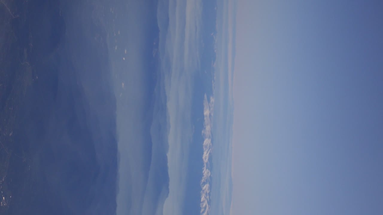 Aerial View of Mountain Range and Clouds