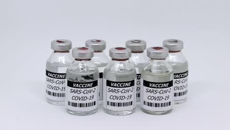 Covid-19-Vaccine-Vial-Over-White-Background---dolly-out-shot