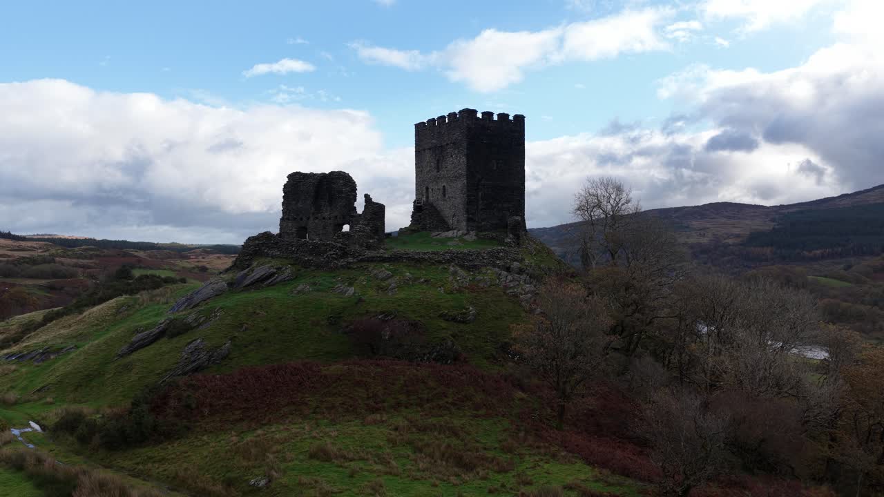 Aerial drone video of Dolwyddelan Castle in Snowdonia National Park, showing the medieval hilltop ruins and the dramatic Welsh highland landscape surrounding this historic stronghold