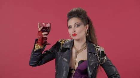 woman in 80s style fashion drinking red wine