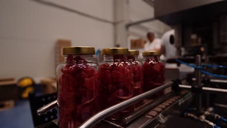 Gummy-bear-supplements-in-clear-bottles-on-conveyor---nutraceutical-industry