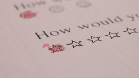 filling out one star with red colored pencil in an evaluation sheet