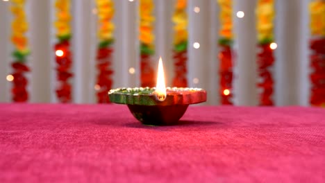 tilt up shot of a burning diya on the occasion of raksha bandhan or diwali