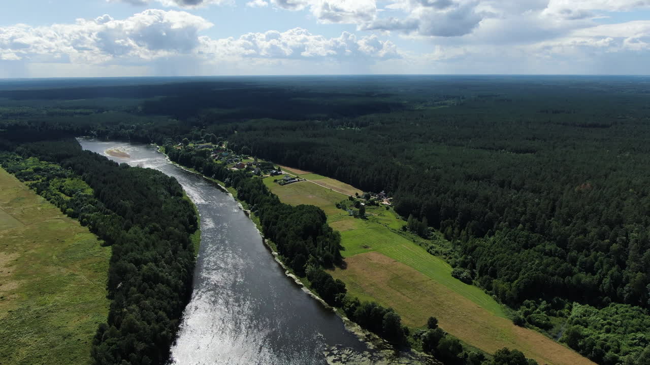 Beautiful small homestead built near river Nemunas and forestry landscape, aerial drone view