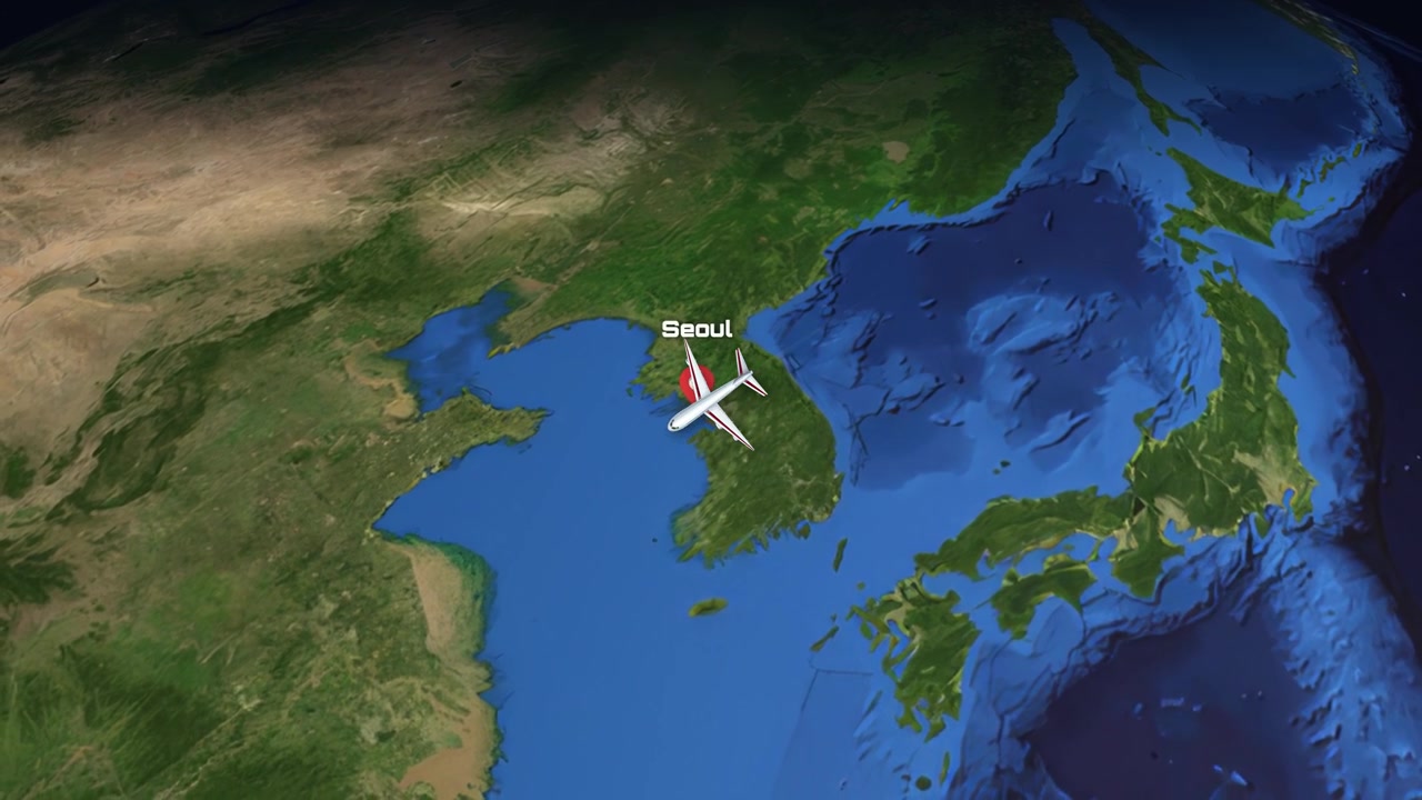 A digital animation tracks an airplane flying across the Pacific Ocean from California to Korea