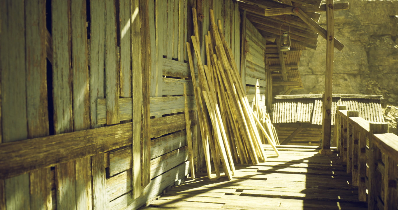 Sunlit wooden structure with leaning sticks on a rustic pathway