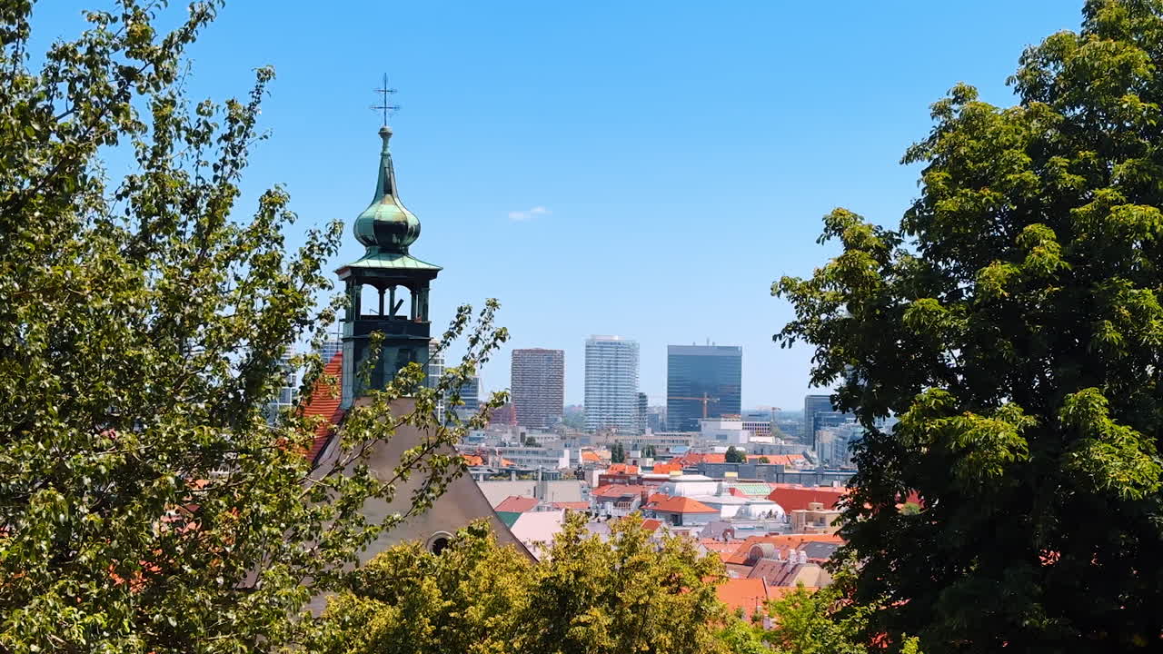 Steeple of the old church with orange roof. High angle view at the old town of Bratislava, Slovakia