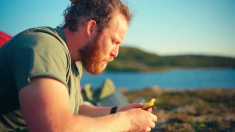 Close-Up-Of-Male-Hiker-Sitting-And-Enjoying-His-Food-In-Indre-Fosen,-Norway