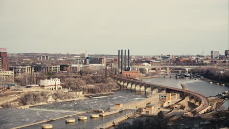 revealing-shot-of-the-Stone-Arch-Bridge-in-downtown-Minneapolis-from-the-deck-of-a-high-rise-condominium