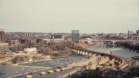 revealing shot of the stone arch bridge in downtown minneapolis from the deck of a high rise condominium