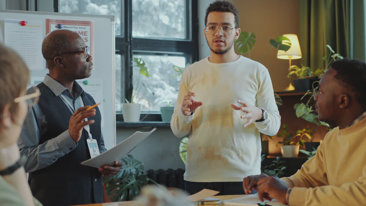 Young Man Speaking on Lesson in School for Immigrants