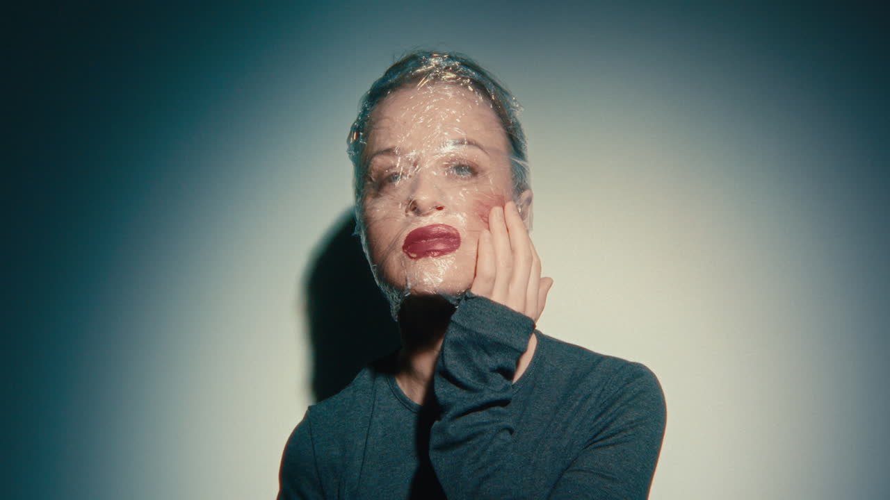Woman with Plastic Wrap over Face