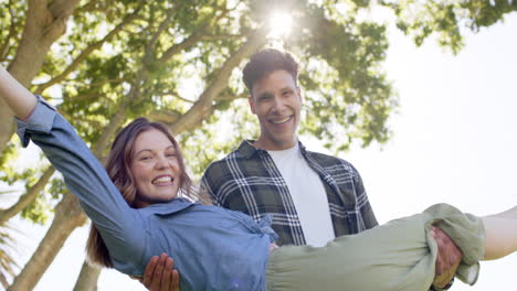 Portrait-of-happy-diverse-couple-in-sunny-garden,-in-slow-motion