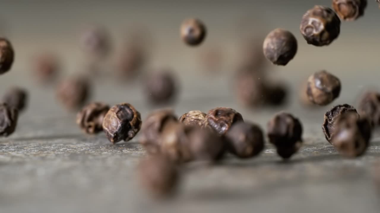 Peppercorns or black pepper spice. Super Macro Close Up. Shot on super slow motion camera 1000 fps.