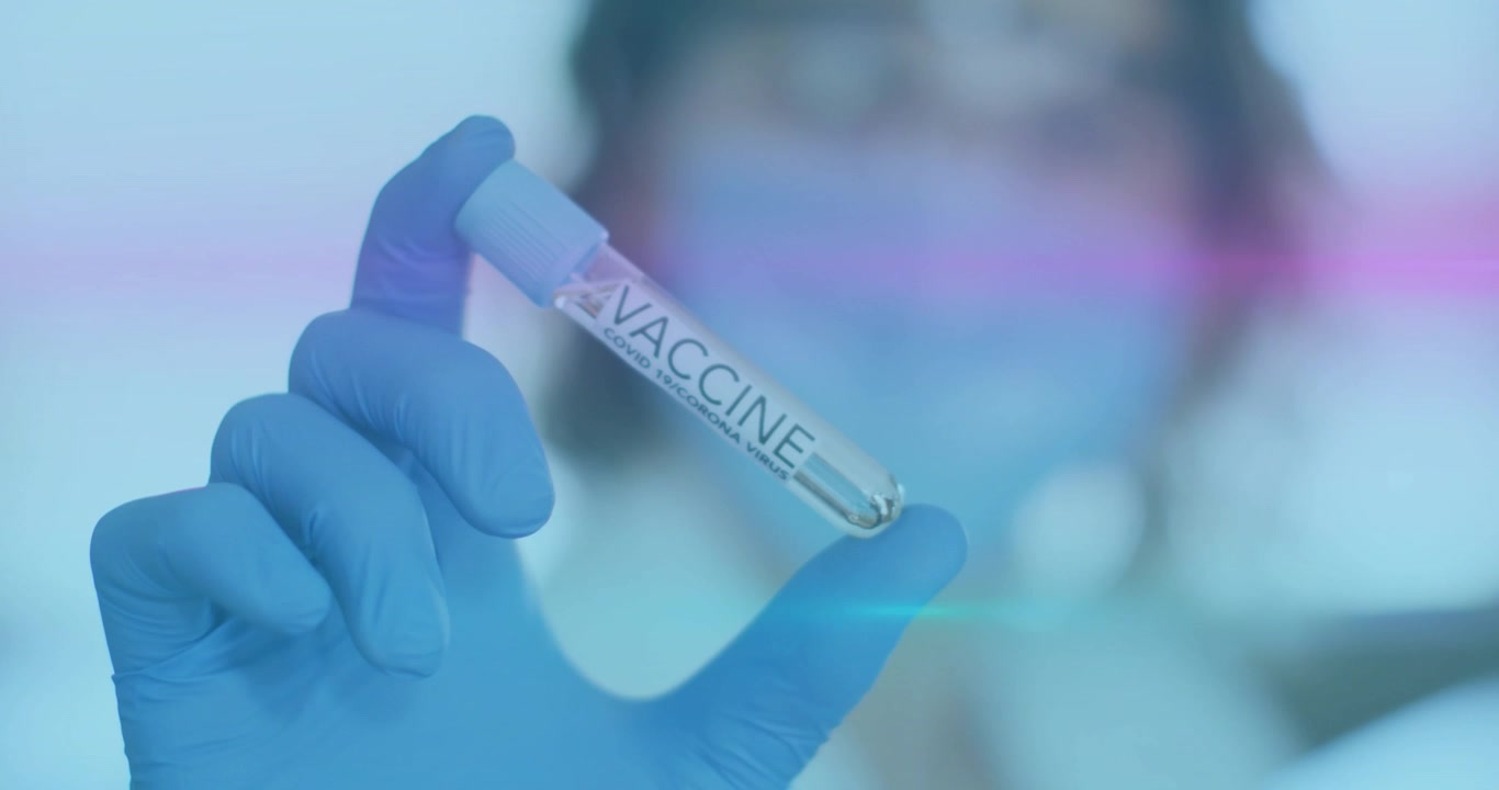 Gloved hand moving vaccine vial closeup in clinic, showing droplet, pink streak crossing over vial