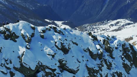 mountaineers resting, looking magnificent valley, col croux, cheneil, mountain range, alps, valtournenche, valle d'aosta, italy. aerial drone backward, panoramic view, copy space