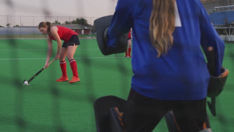 female hockey players playing on the field