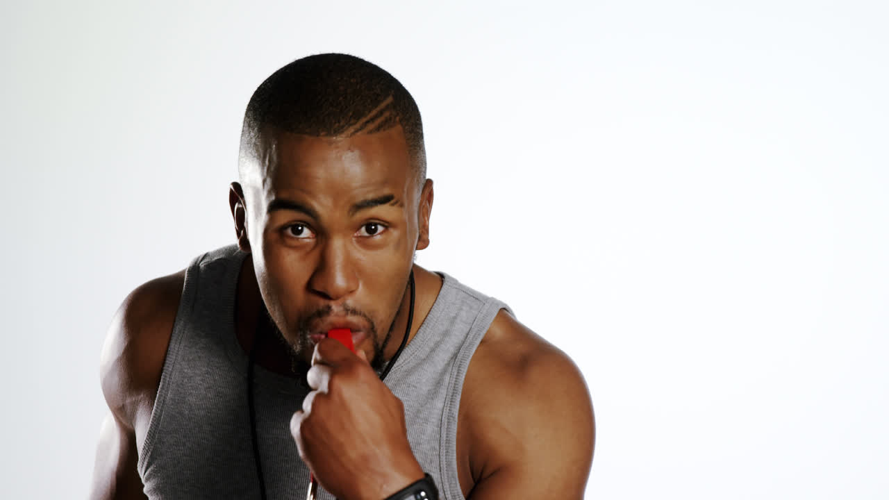 Portrait of trainer blowing a whistle