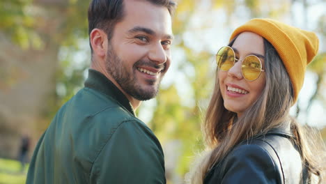 rear view of caucasian woman wearing glasses and beanie and caucasian man