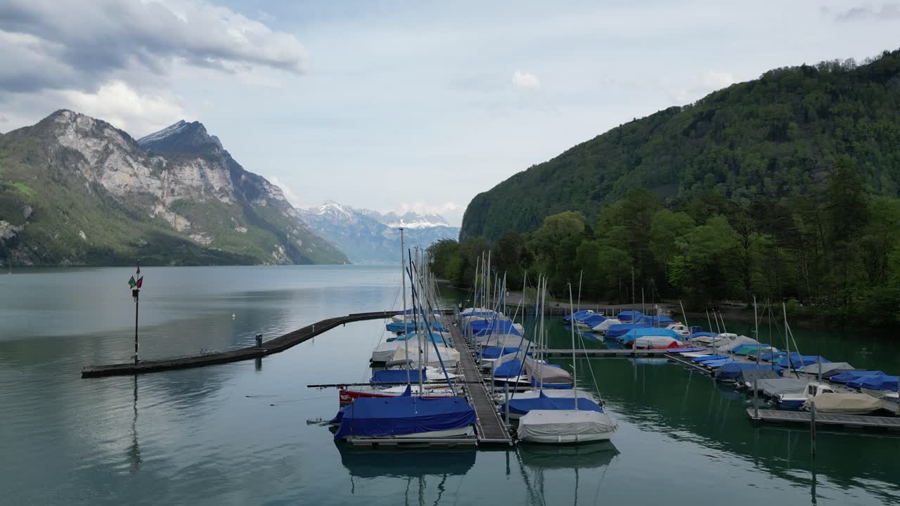 Boats on the lake in front of a small village in G&auml;si Betlis, Walensee Glarus, Weesen Walenstadt, Switzerland