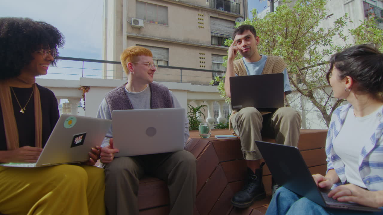 Gen Z People Working with Laptops and Having Talk Outdoor in the City