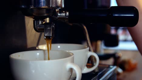 machine making a cup of coffee