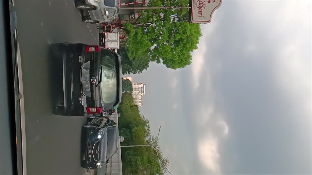 Road and traffic atmosphere in downtown Bandung, Indonesia in slow motion. vertical shot.